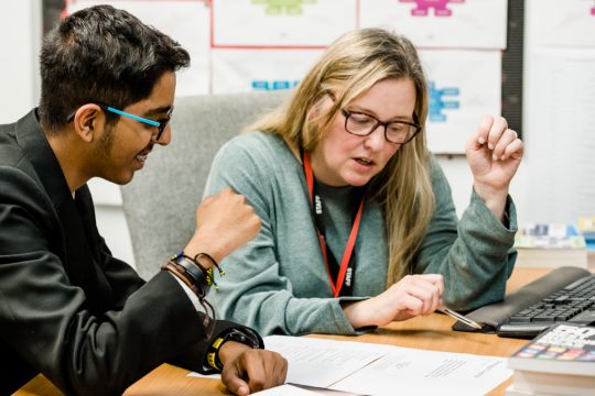 A school pupil receiving personal careers guidance from a careers adviser in a school library