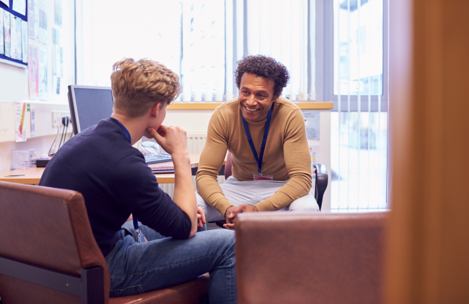 A college student talks to a staff member about their the opportunities available to them.