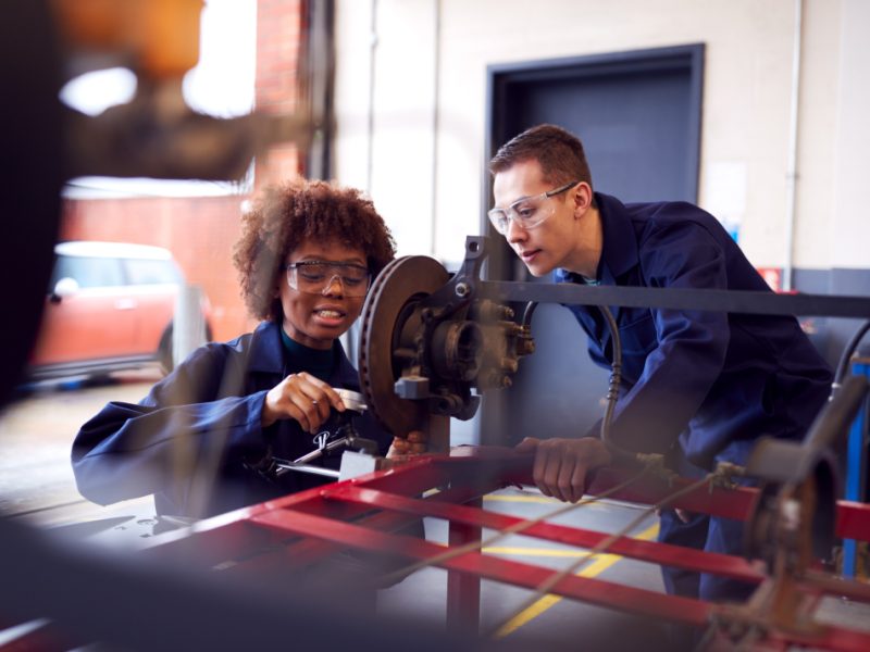 Students working with equipment in an engineering workshop