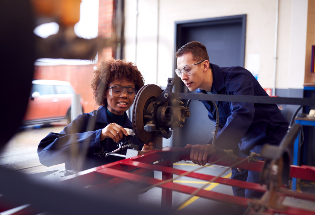 Students working with equipment in an engineering workshop